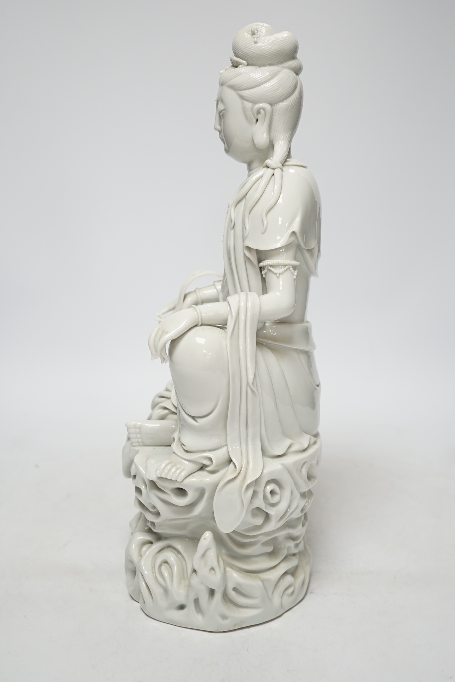 A late 19th / early 20th century Chinese blanc de Chine seated figure of Guanyin, impressed mark to back, 38cm